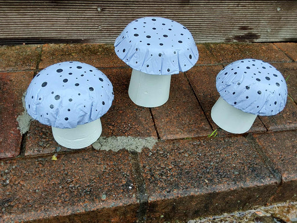 Set of 3 light purple concrete mushrooms.