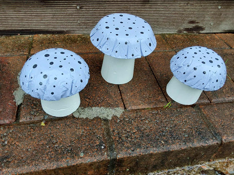 Set of 3 light purple concrete mushrooms.