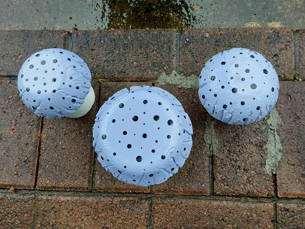 Set of 3 light purple concrete mushrooms.