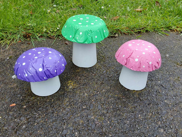 Set of 3 mixed coloured concrete mushrooms.