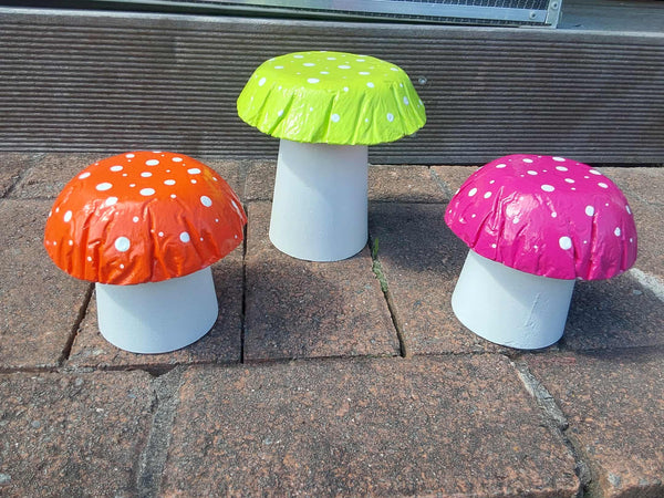 Set of 3 multi coloured concrete mushrooms.