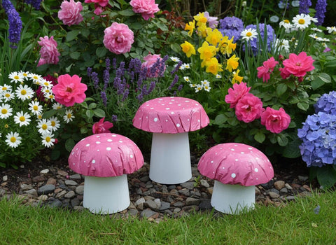 Set of 3 pink concrete mushrooms.
