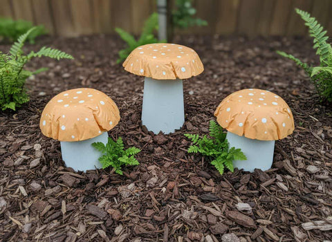 Set of 3 pastel orange concrete mushrooms.