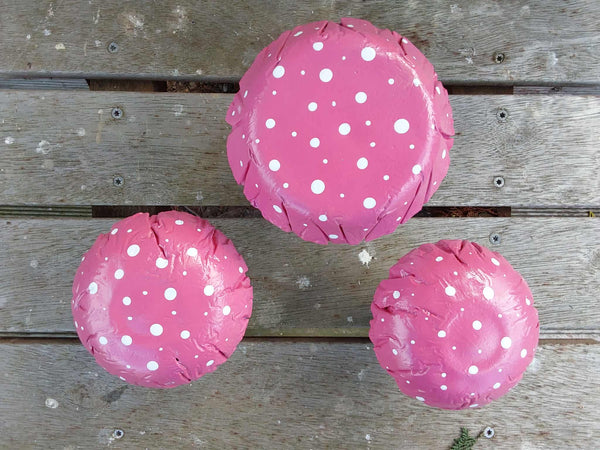 Set of 3 pink concrete mushrooms.