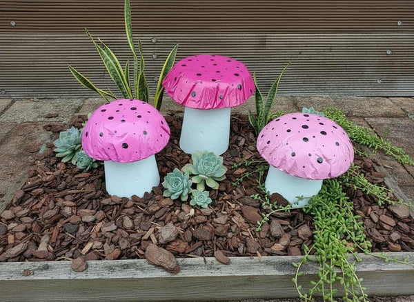 Set of 3 pink concrete mushrooms.