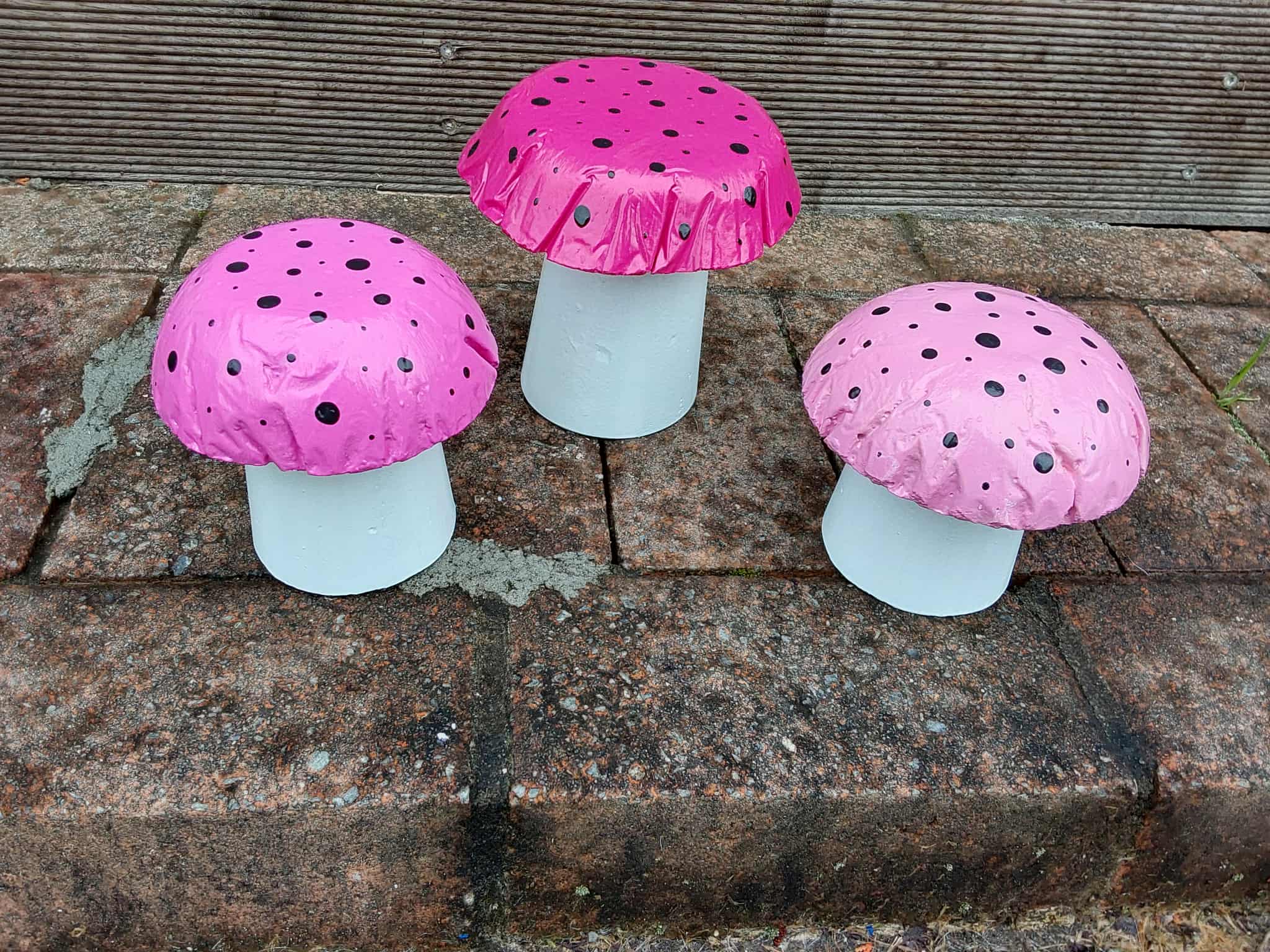 Set of 3 pink concrete mushrooms.