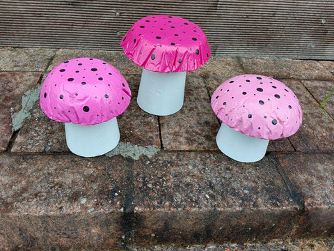 Set of 3 pink concrete mushrooms.