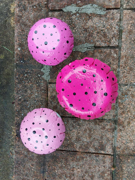 Set of 3 pink concrete mushrooms.