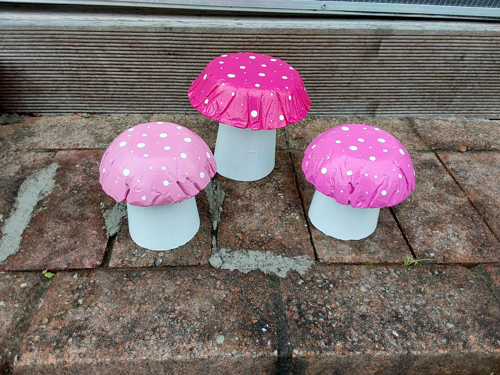 Set of 3 pink concrete mushrooms.