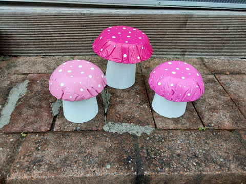 Set of 3 pink concrete mushrooms.