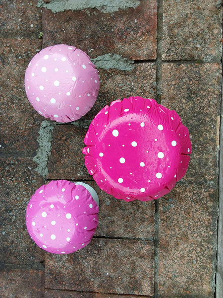 Set of 3 pink concrete mushrooms.