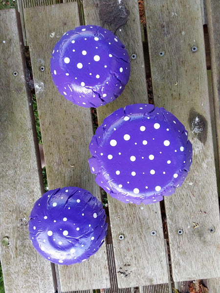 Set of 3 purple concrete mushrooms.